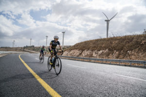 bike riders near wind turbines