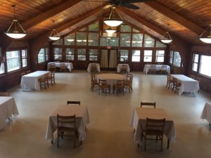 Dining hall with well-spaced tables for COVID-safe indoor dining